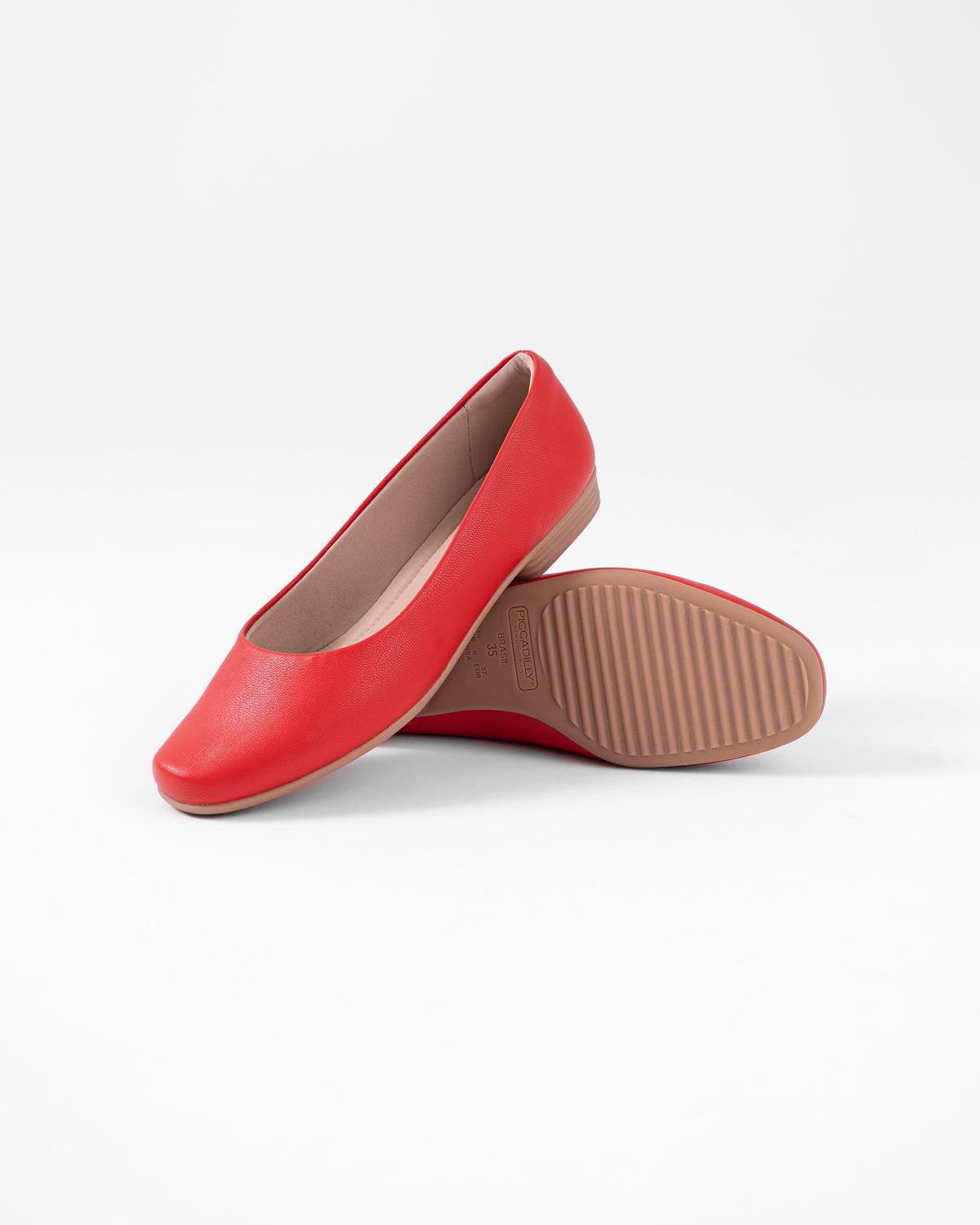 The Piccadilly Chic Flat - Red (Ref 250166-140) features one upright and one sideways shoe showing its textured sole, combining style and comfort for women, all set against a plain white background.