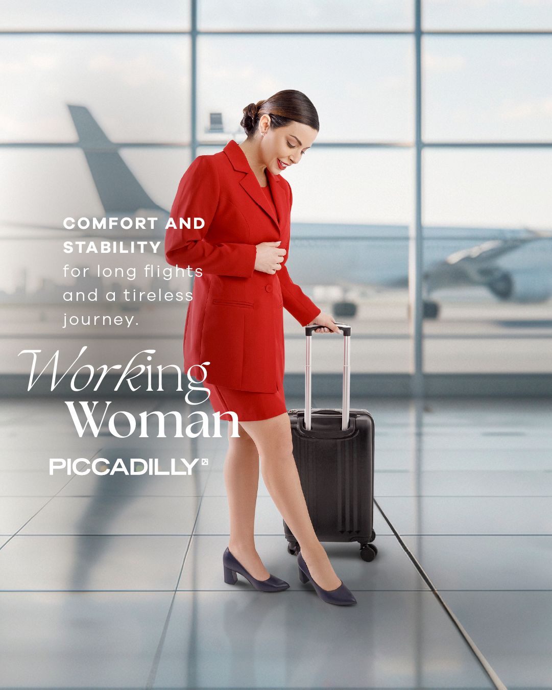 A woman in a red suit stands in an airport with a suitcase, wearing Piccadilly Ref: 439A Flight Attendant Terminal & Cabin Shoes—comfortable airline crew footwear. Comfort and stability for long flights. Working Woman. PICCADILLY.
