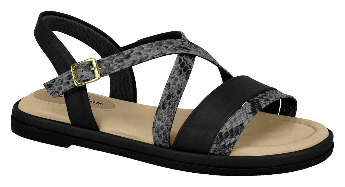 The Modare 7139.104 Women Flat Fashion Sandal Travel Casual Shoe in Black features a cushioned beige insole, black sole, black and gray snake print crisscross straps, plus a gold buckle—ideal for stylish all-day comfort.